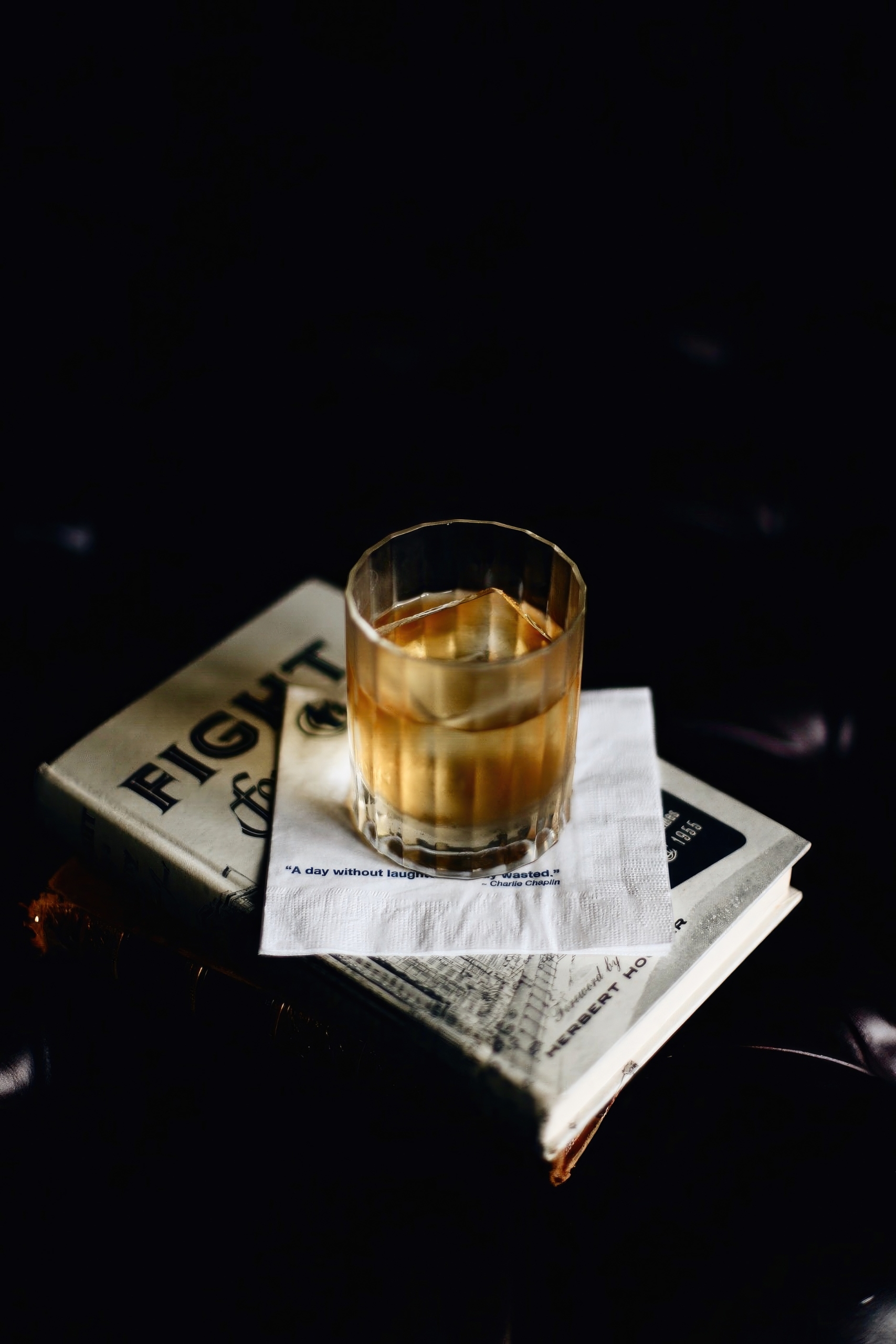 Los Angeles Athletic Club whiskey resting on a newspaper.