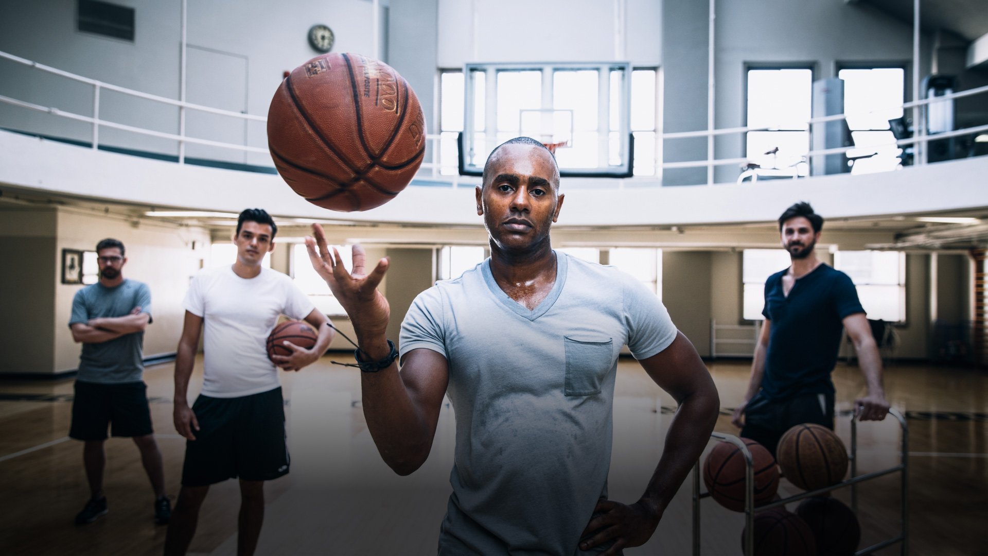 LAAC Hotel indoor basketball field with a dynamic group of men showcasing their basketball skills in a vibrant gymnasium. Experience the thrill of the game!