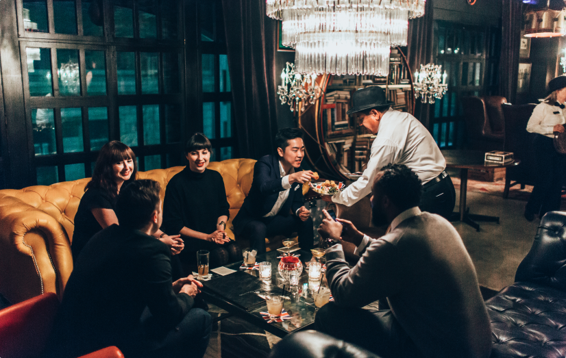 People gathered around a table, chatting and laughing at LA Athletic Club