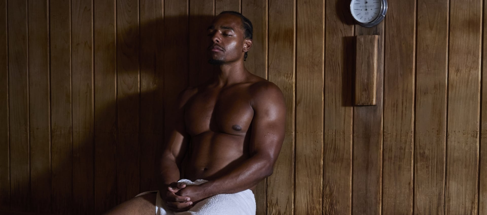 A man sitting in a sauna.
