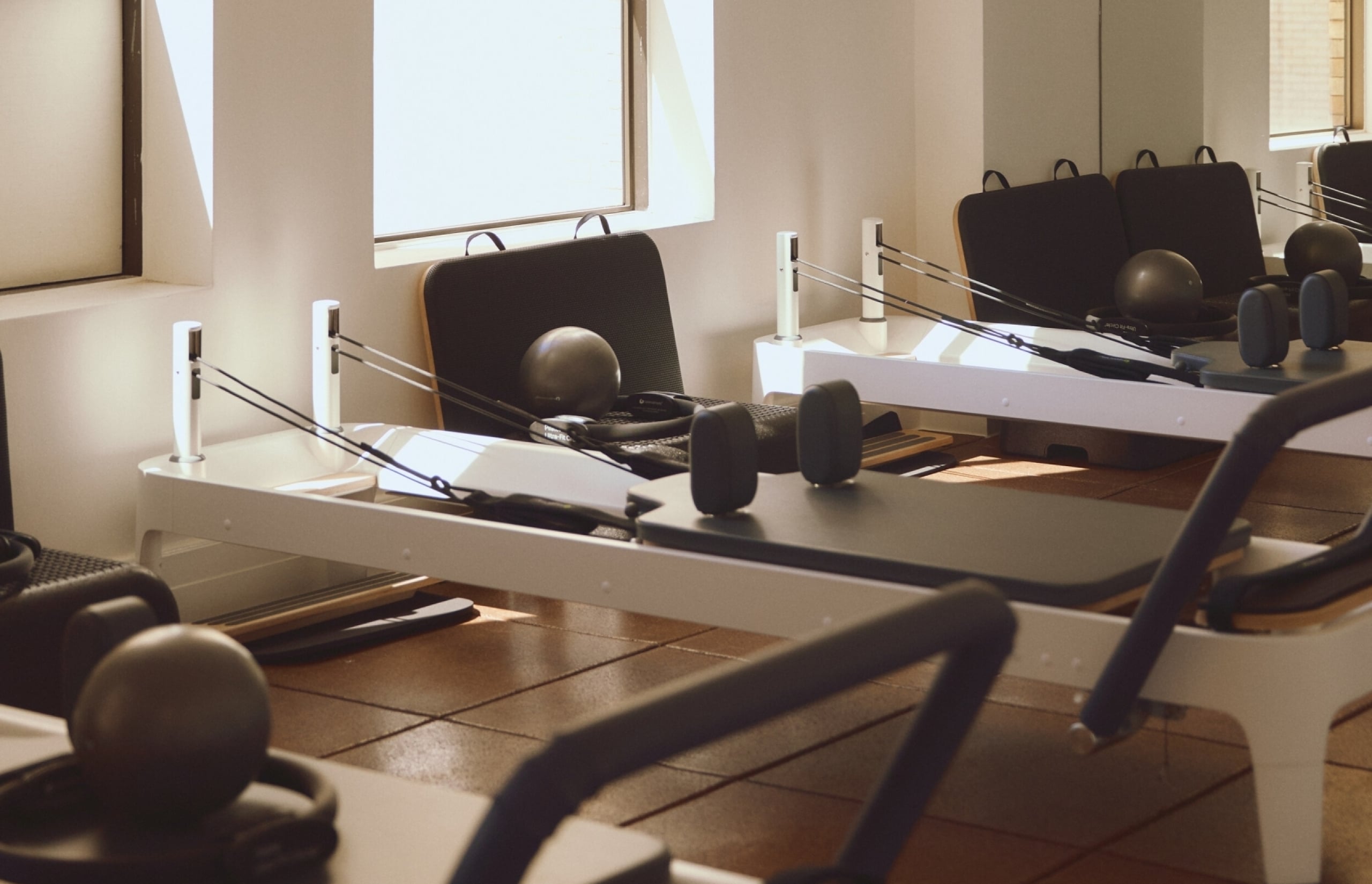 A calm pilates studio with reformers and equipment