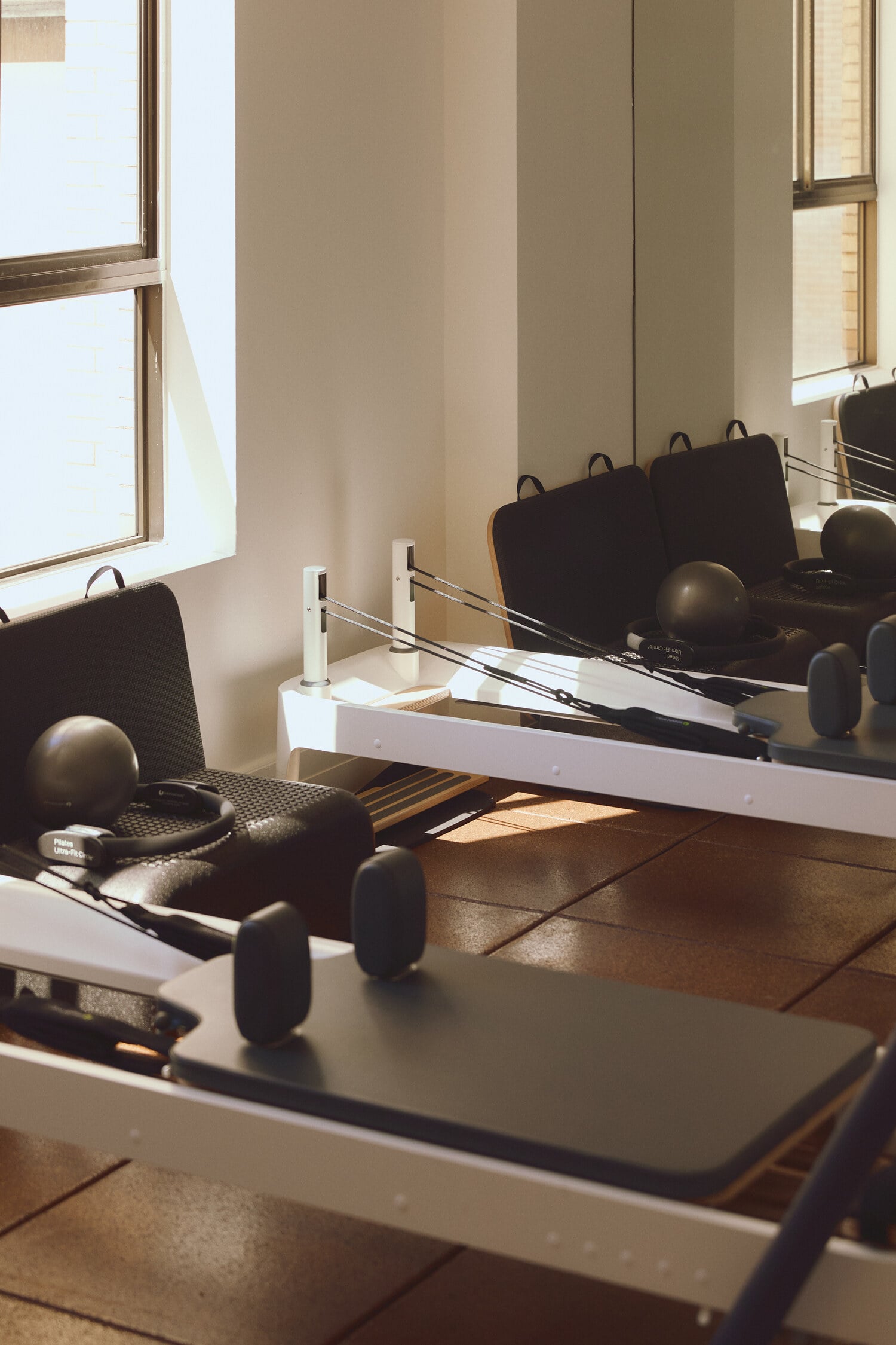 A calm pilates studio with reformers and equipment